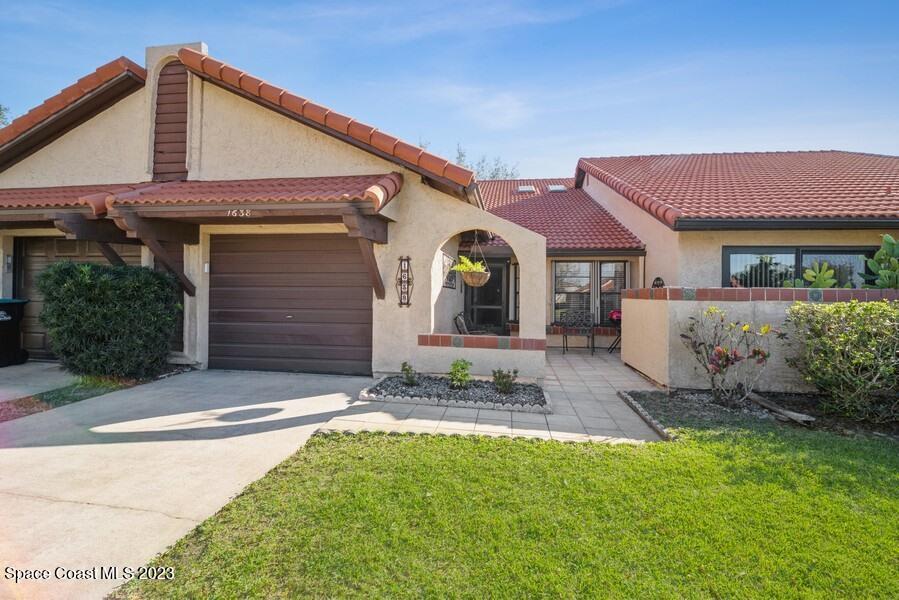 1638 Dawes Road Northeast Palm Bay, FL 32905 - Photo 1 of 26 a front view of a house with a yard and garage