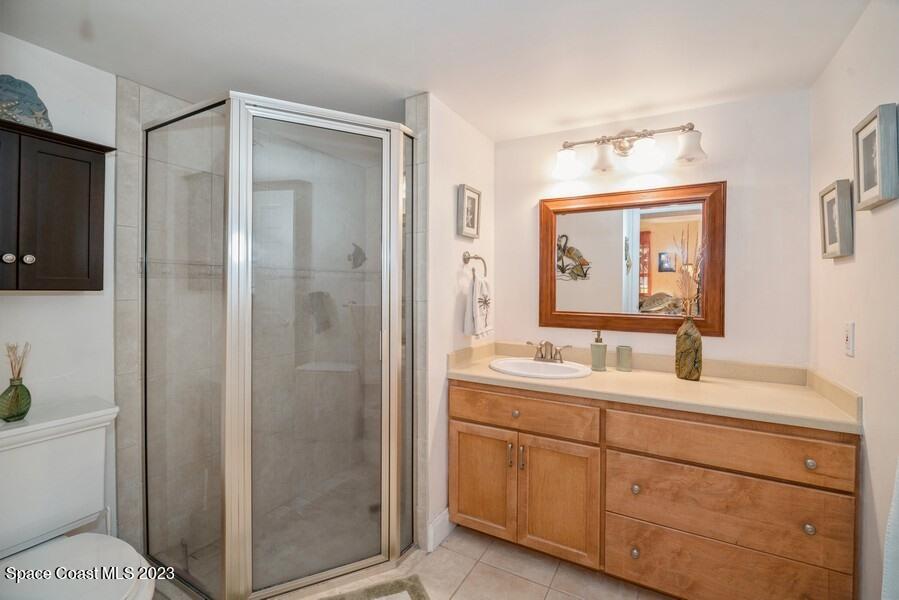 1638 Dawes Road Northeast Palm Bay, FL 32905 - Photo 12 of 26 a bathroom with a double vanity sink mirror and toilet