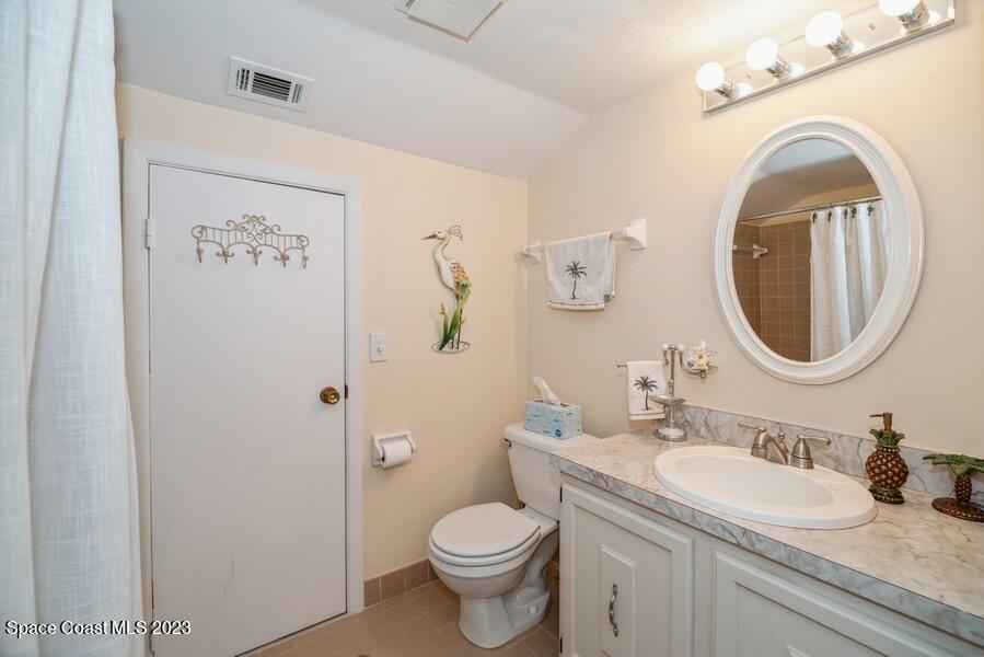 1638 Dawes Road Northeast Palm Bay, FL 32905 - Photo 15 of 26 a bathroom with a granite countertop toilet sink and a mirror