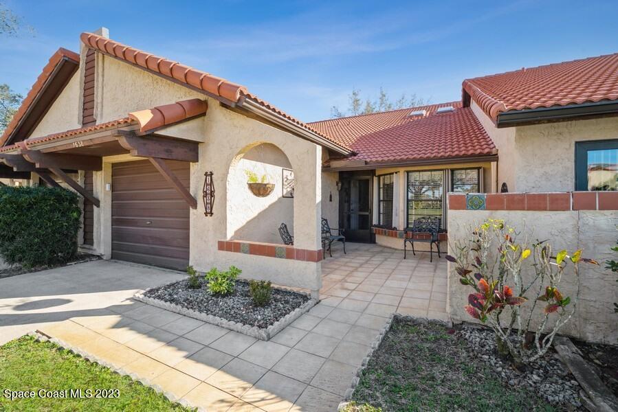 1638 Dawes Road Northeast Palm Bay, FL 32905 - Photo 2 of 26 a front view of a house with garden