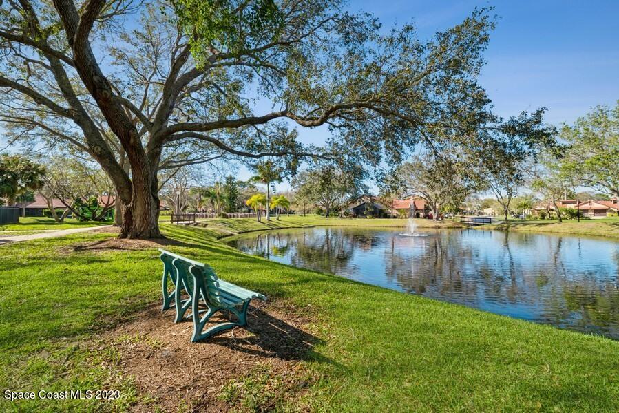 1638 Dawes Road Northeast Palm Bay, FL 32905 - Photo 24 of 26 a view of lake with a bench and trees around