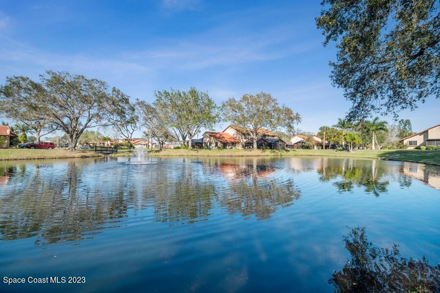 1638 Dawes Road Northeast Palm Bay, FL 32905 - Photo 25 of 26 a view of a lake with houses in the background