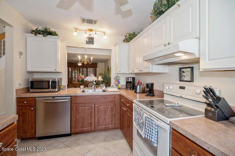 1638 Dawes Road Northeast Palm Bay, FL 32905 - Photo 5 of 26 a kitchen with a sink stove and cabinets
