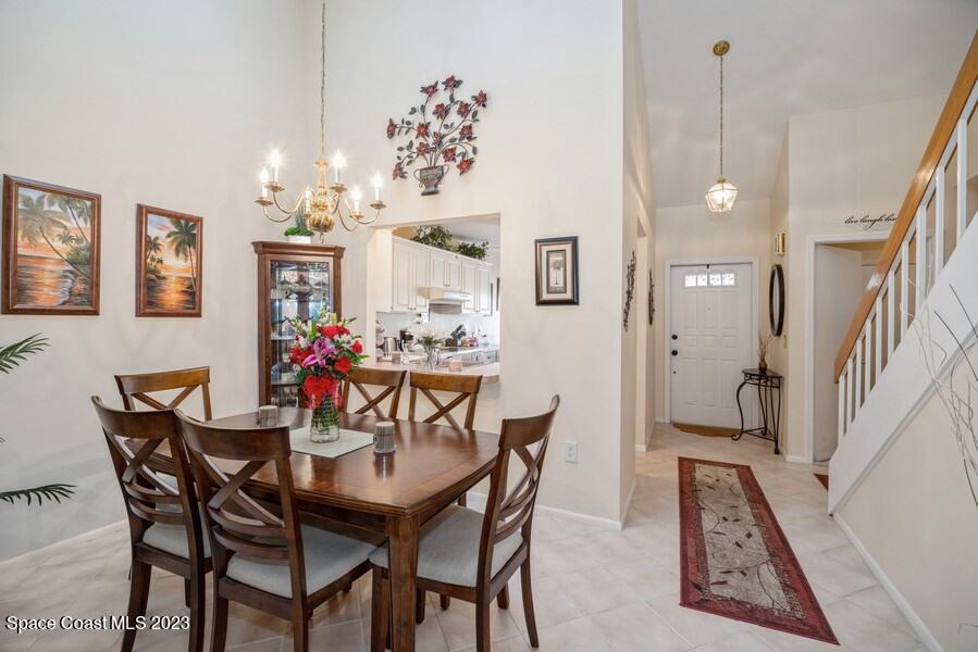 1638 Dawes Road Northeast Palm Bay, FL 32905 - Photo 7 of 26 a view of a dining room with furniture and a chandelier