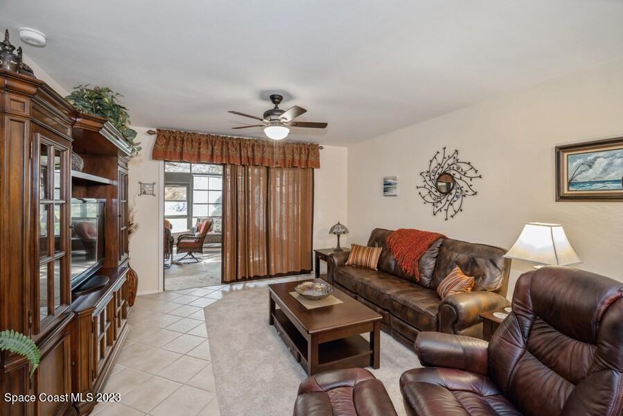 1638 Dawes Road Northeast Palm Bay, FL 32905 - Photo 8 of 26 a living room with furniture and a flat screen tv