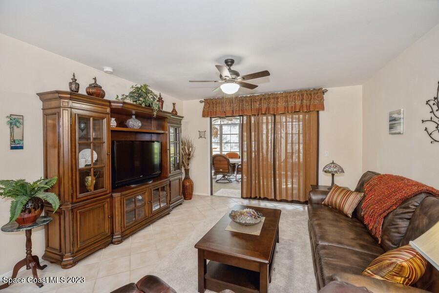 1638 Dawes Road Northeast Palm Bay, FL 32905 - Photo 9 of 26 a living room with furniture and a flat screen tv
