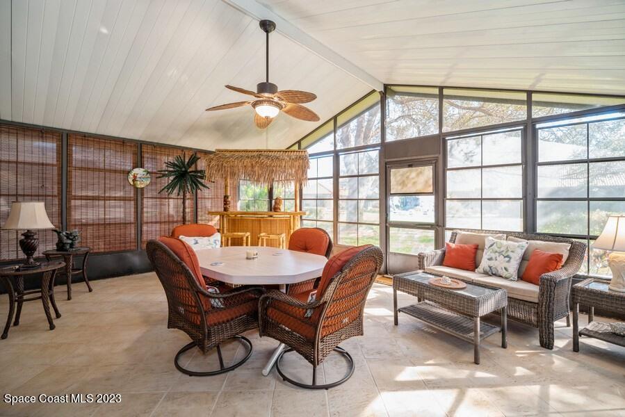 1638 Dawes Road Northeast Palm Bay, FL 32905 - Photo 10 of 26 a dining room with furniture wooden floor and a rug