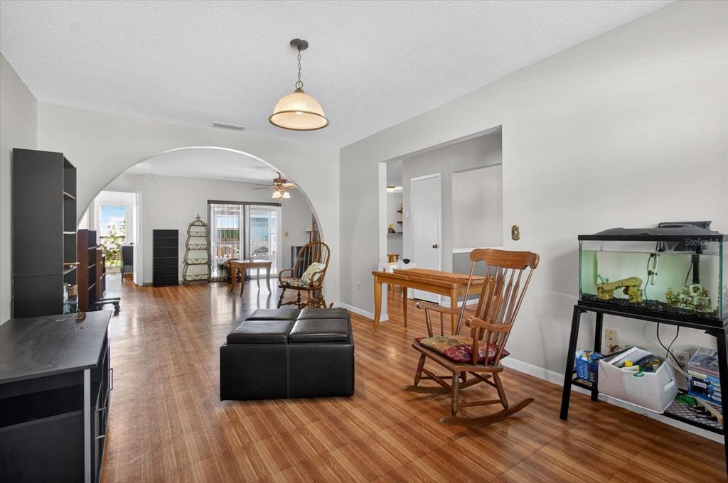 750 Caliente Drive Brandon, FL 33511 - Photo 11 of 71 a view of a dining room with furniture a chandelier and wooden floor
