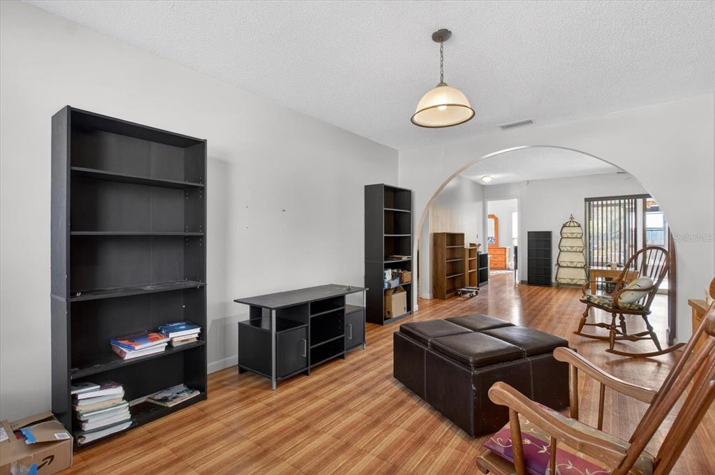 750 Caliente Drive Brandon, FL 33511 - Photo 12 of 71 a living room with furniture a fireplace and a chandelier