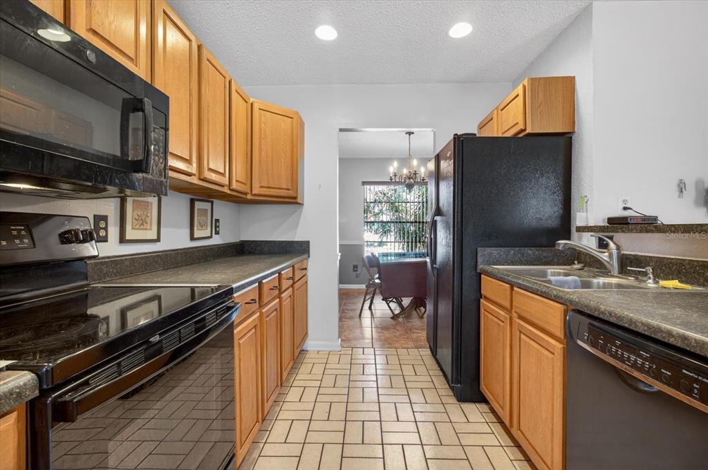 750 Caliente Drive Brandon, FL 33511 - Photo 17 of 71 a kitchen with stainless steel appliances granite countertop a stove and a sink