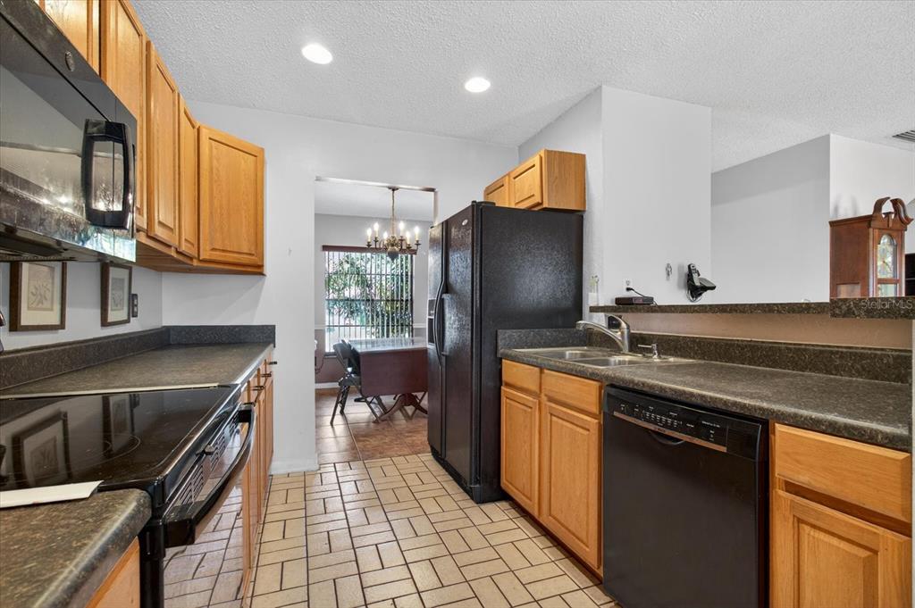 750 Caliente Drive Brandon, FL 33511 - Photo 18 of 71 a kitchen with granite countertop a sink stove and refrigerator