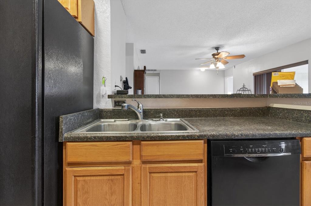 750 Caliente Drive Brandon, FL 33511 - Photo 19 of 71 a kitchen with granite countertop a sink stainless steel appliances and cabinets