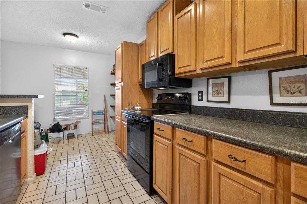 750 Caliente Drive Brandon, FL 33511 - Photo 20 of 71 a kitchen with stainless steel appliances granite countertop a stove a sink dishwasher and cabinets with wooden floor