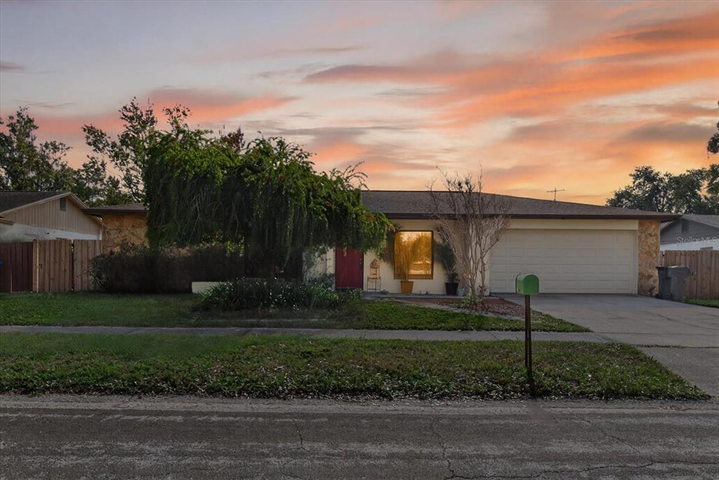 750 Caliente Drive Brandon, FL 33511 - Photo 2 of 71 a view of a white house with a yard and plants