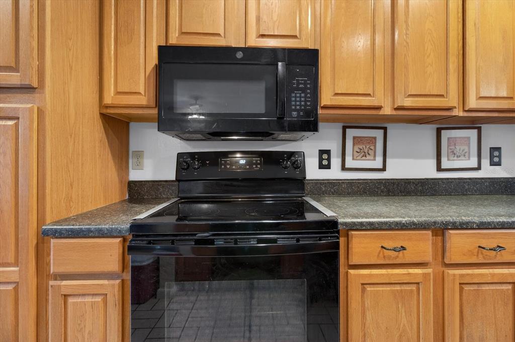 750 Caliente Drive Brandon, FL 33511 - Photo 21 of 71 a kitchen with granite countertop a stove and a microwave