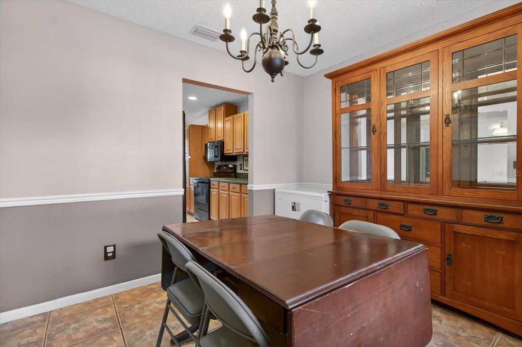 750 Caliente Drive Brandon, FL 33511 - Photo 25 of 71 a view of a dining room with furniture and chandelier