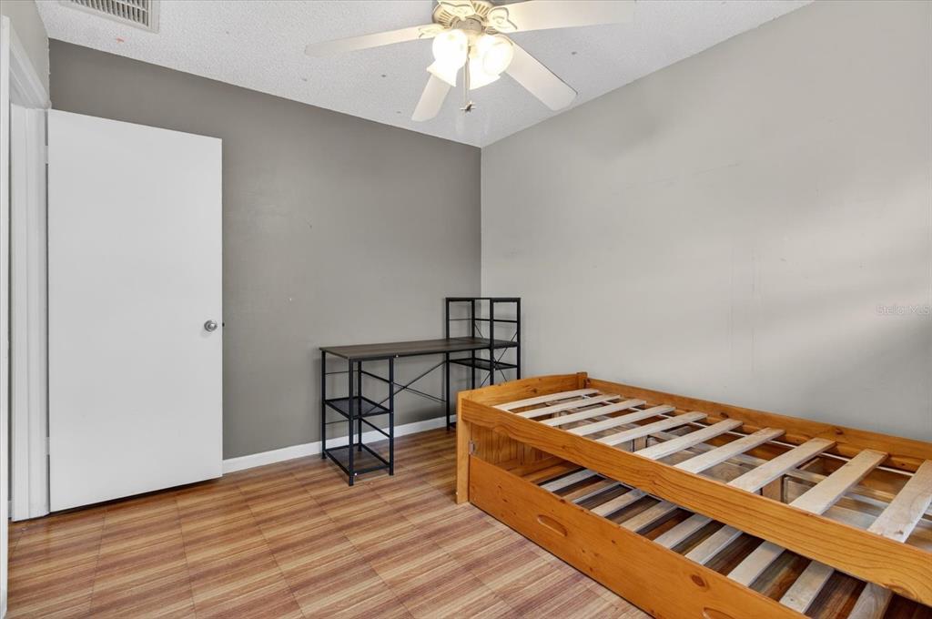 750 Caliente Drive Brandon, FL 33511 - Photo 43 of 71 a bedroom with a bed and a chandelier