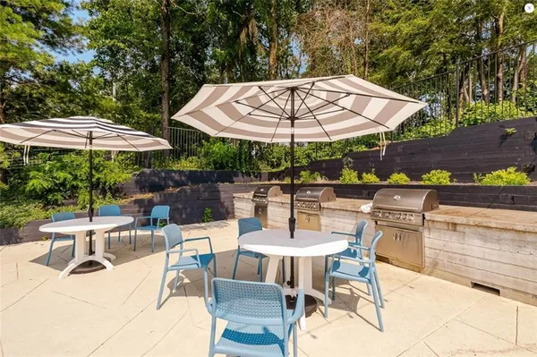 an outdoor space with patio and white umbrellas