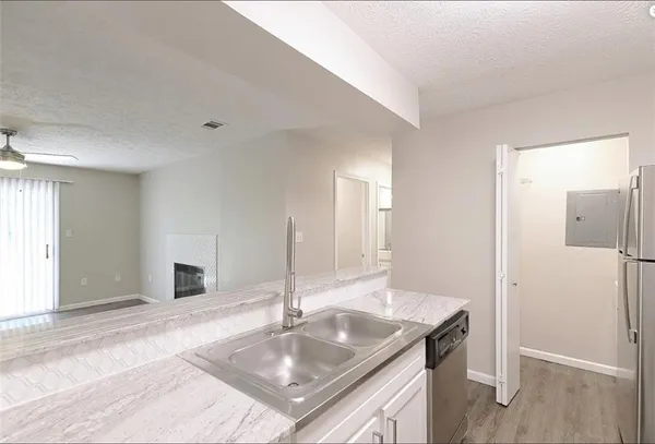 a kitchen with a sink cabinets and a refrigerator