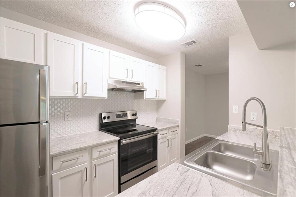 916 Beaver Grade Road Coraopolis, PA 15108 - Photo 7 of 17 a kitchen with a refrigerator sink and cabinets