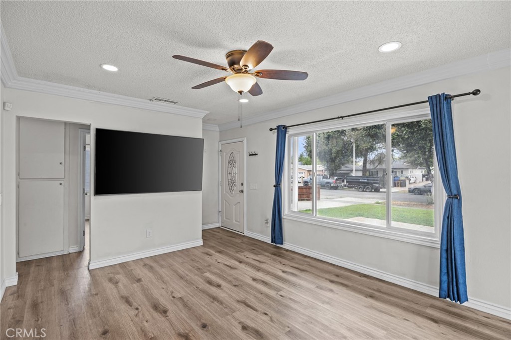 10028 Primrose Drive Riverside, CA 92503 - Photo 4 of 19 a view of empty room with wooden floor and fan