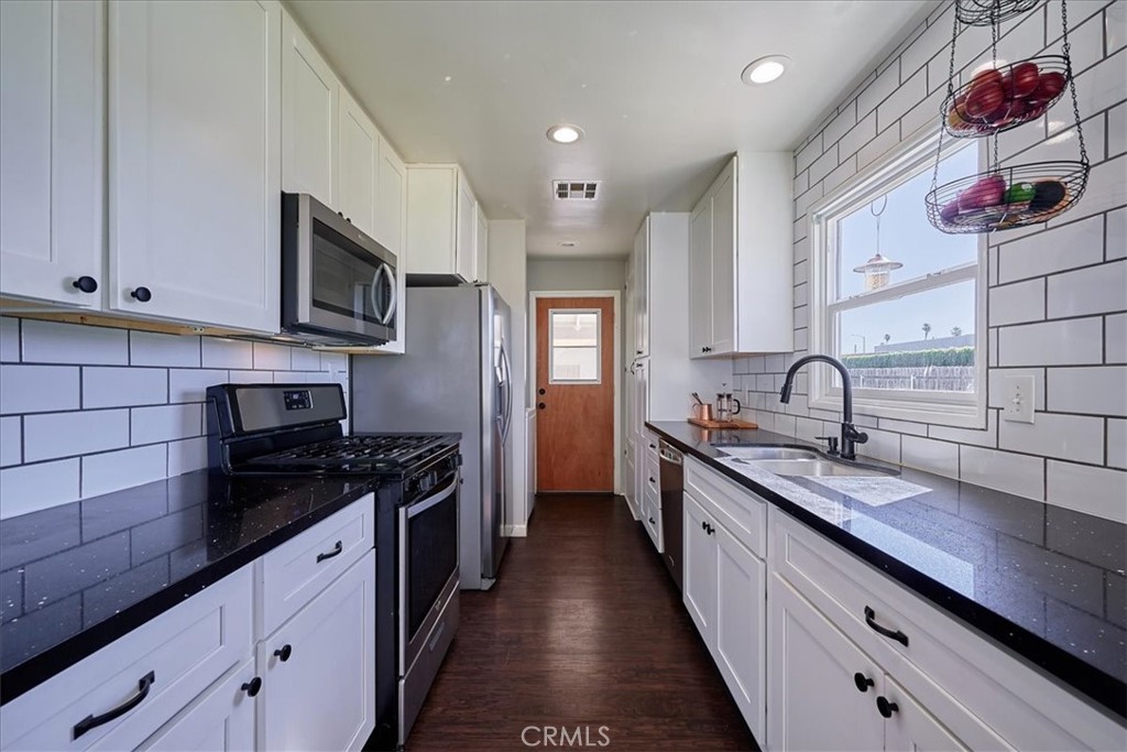 3469 Verde Street Riverside, CA 92504 - Photo 13 of 38 a kitchen with stainless steel appliances granite countertop a sink and cabinets