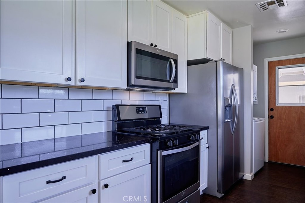 3469 Verde Street Riverside, CA 92504 - Photo 14 of 38 a kitchen with granite countertop a stove and a microwave
