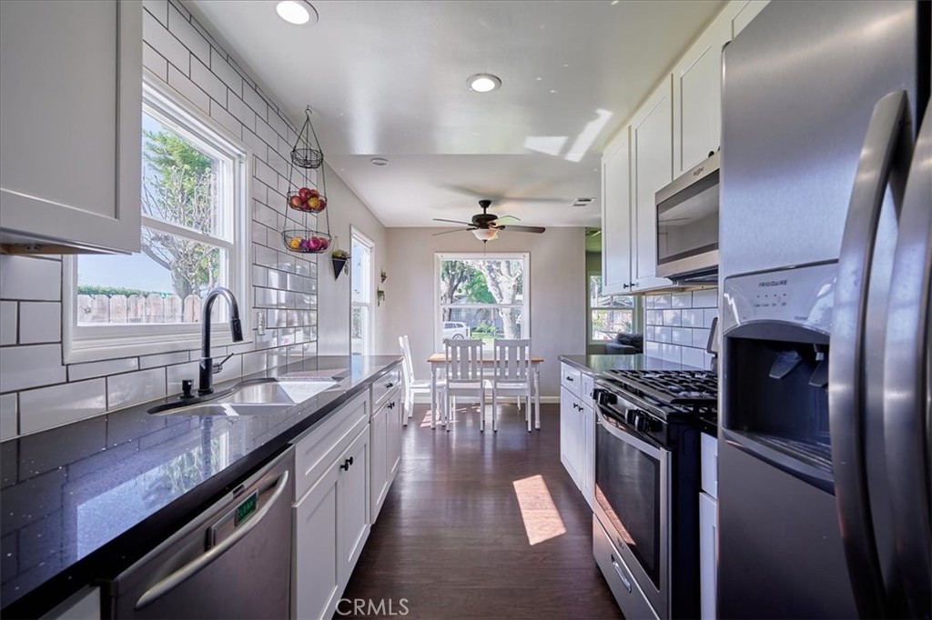 3469 Verde Street Riverside, CA 92504 - Photo 17 of 38 a kitchen with stainless steel appliances a sink stove and cabinets