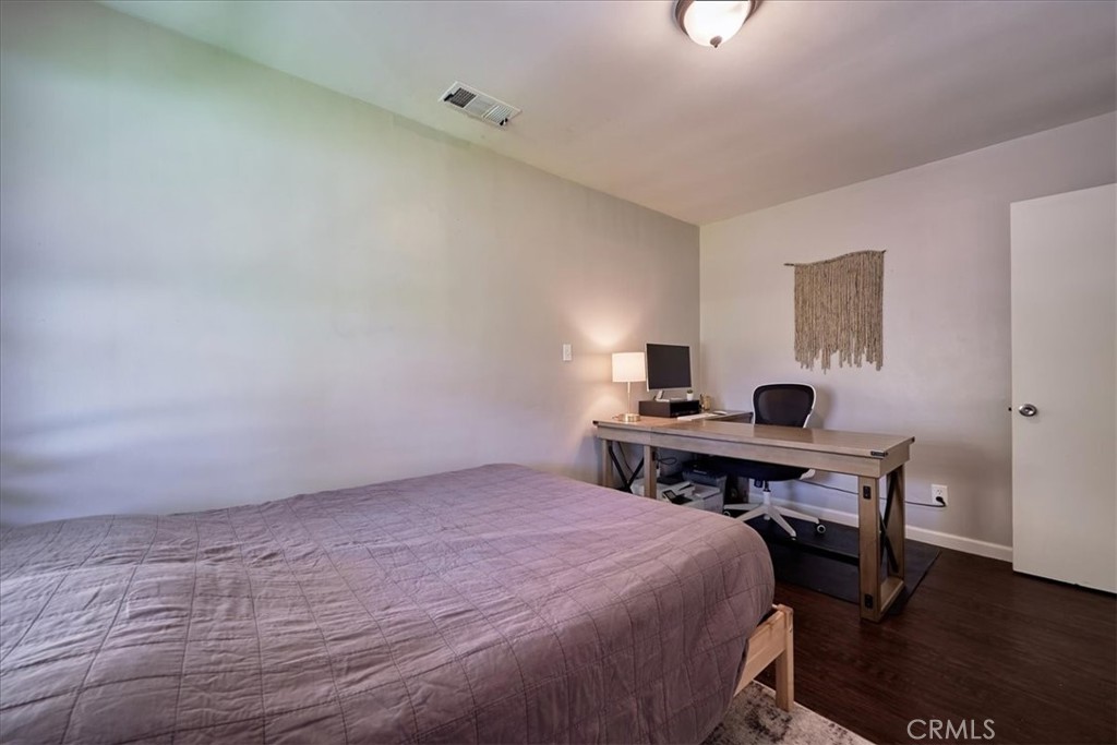 3469 Verde Street Riverside, CA 92504 - Photo 26 of 38 a bedroom with a bed and a table in it