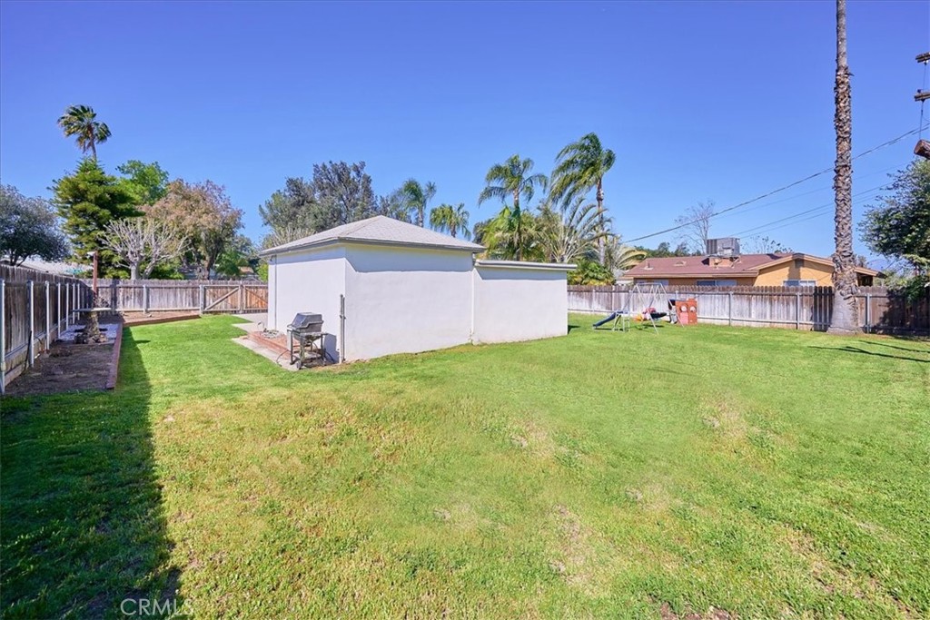 3469 Verde Street Riverside, CA 92504 - Photo 32 of 38 a view of a house with a yard and a fence