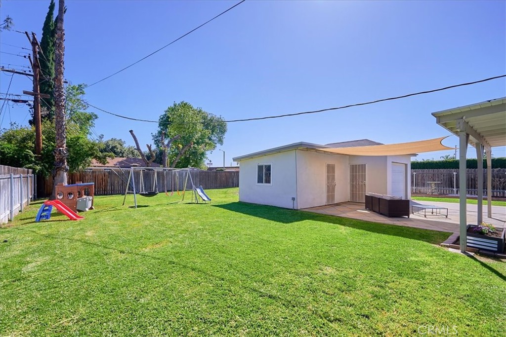 3469 Verde Street Riverside, CA 92504 - Photo 35 of 38 a view of a backyard with table and chairs and wooden fence