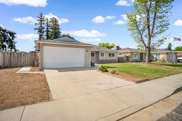a front view of a house with a garden and yard