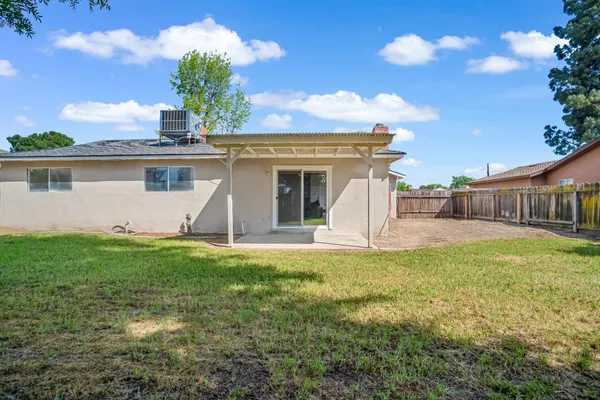 a view of a house with backyard and sitting area