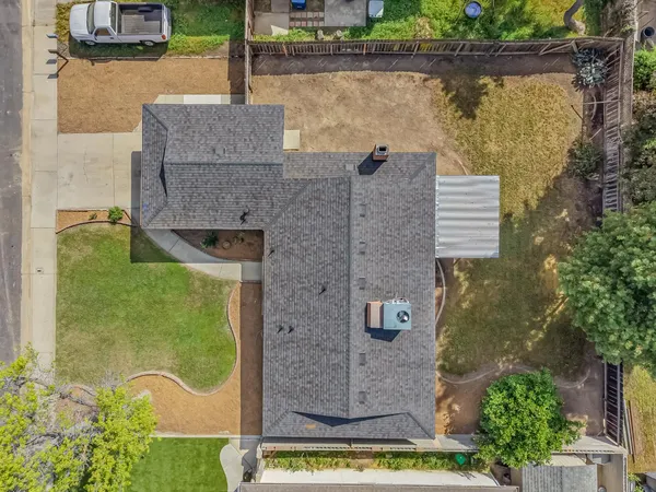 an aerial view of a house with a yard