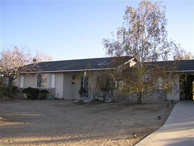 1621 Locust Road Pinon Hills, CA 92372 - Photo 1 of 1 a view of a house with a backyard and trees