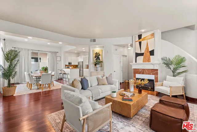 a living room with fireplace furniture and a wooden floor