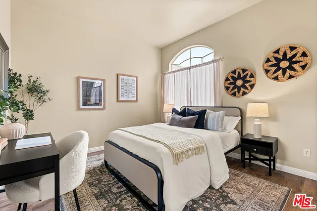 a spacious bedroom with a bed and a table