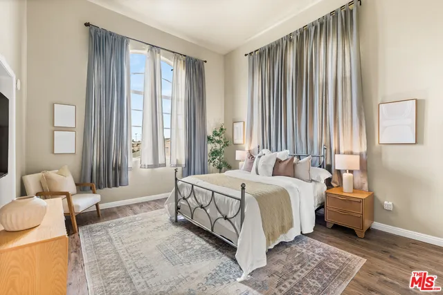 a bedroom with a bed and a couch