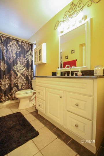 632 South Nevada Street Ridgecrest, CA 93555 - Photo 17 of 29 a bathroom with a sink a toilet and mirror