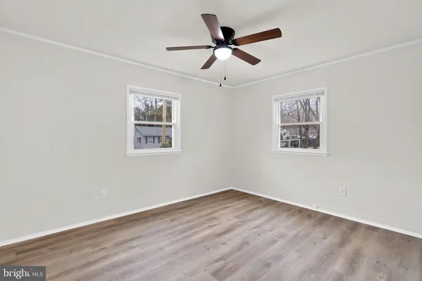 a view of empty room with wooden floor