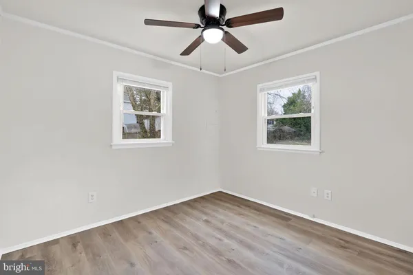 a view of empty room with wooden floor