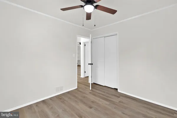 a view of an empty room with wooden floor
