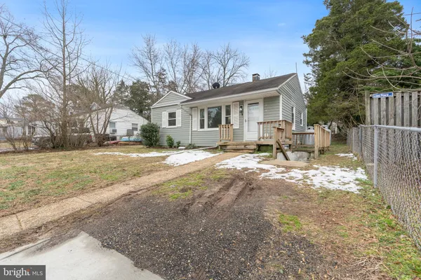 a view of a house with a yard covered in snow