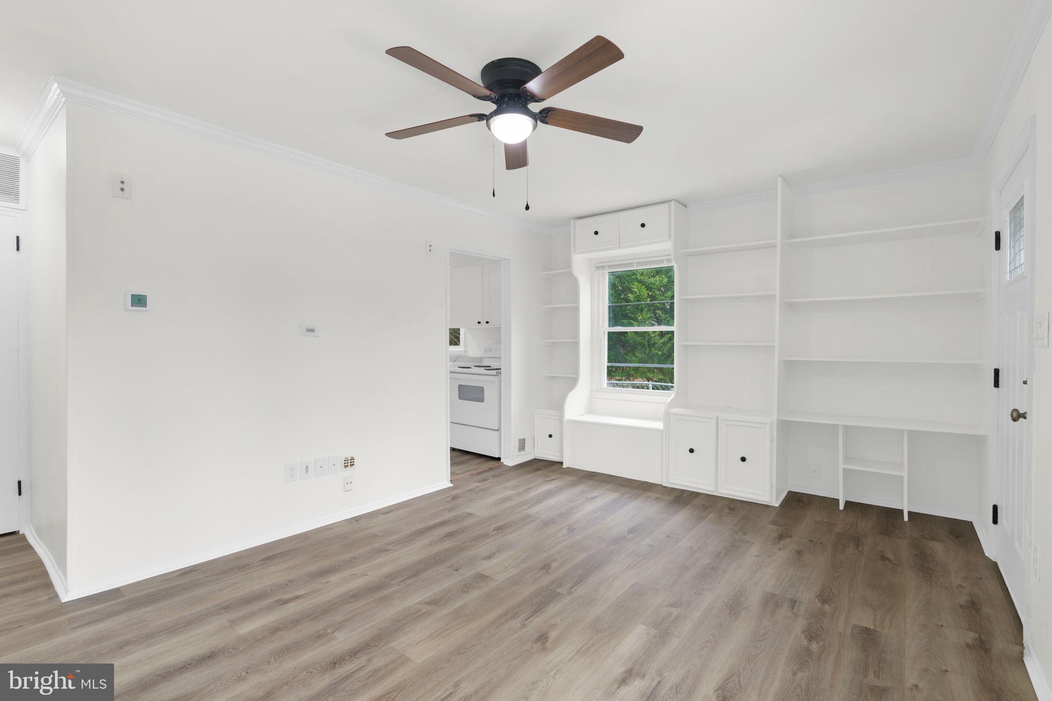 46423 Franklin Road Lexington Park, MD 20653 - Photo 8 of 25 an empty room with wooden floor chandelier fan and windows