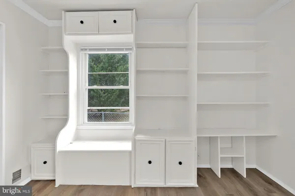 a room with a window and a wooden floor