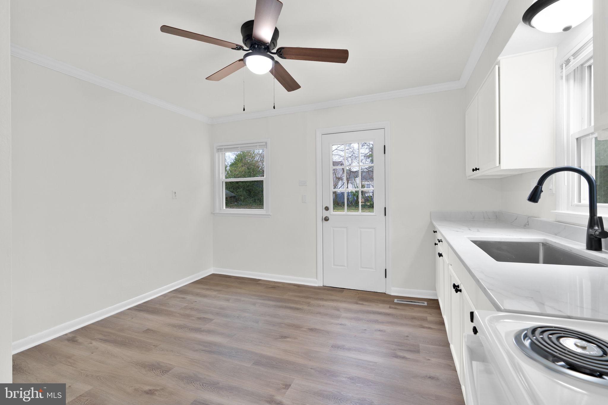 46423 Franklin Road Lexington Park, MD 20653 - Photo 10 of 25 a view of a kitchen with a sink hardwood floor and a ceiling fan