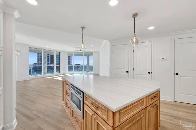 a kitchen with kitchen island a sink stainless steel appliances and cabinets