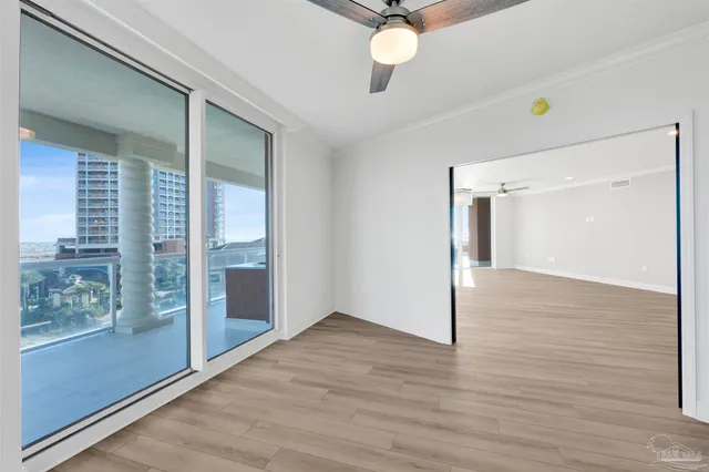 a view of a livingroom with wooden floor and window
