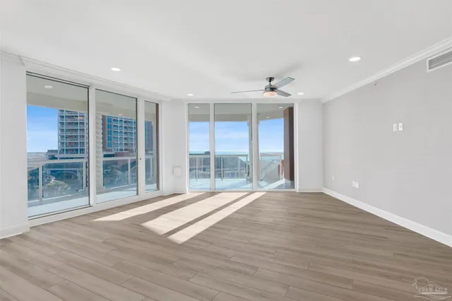 a view of a kitchen with kitchen island a sink stainless steel appliances and a window