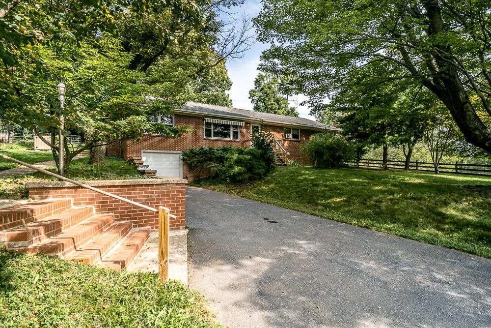 a view of house with yard